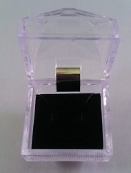  A small, transparent plastic jewelry box with a black cushioned interior is open, showing its empty contents against a plain background. 