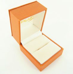  Open orange jewelry box with white interior, labeled "Pearl" inside the lid. 